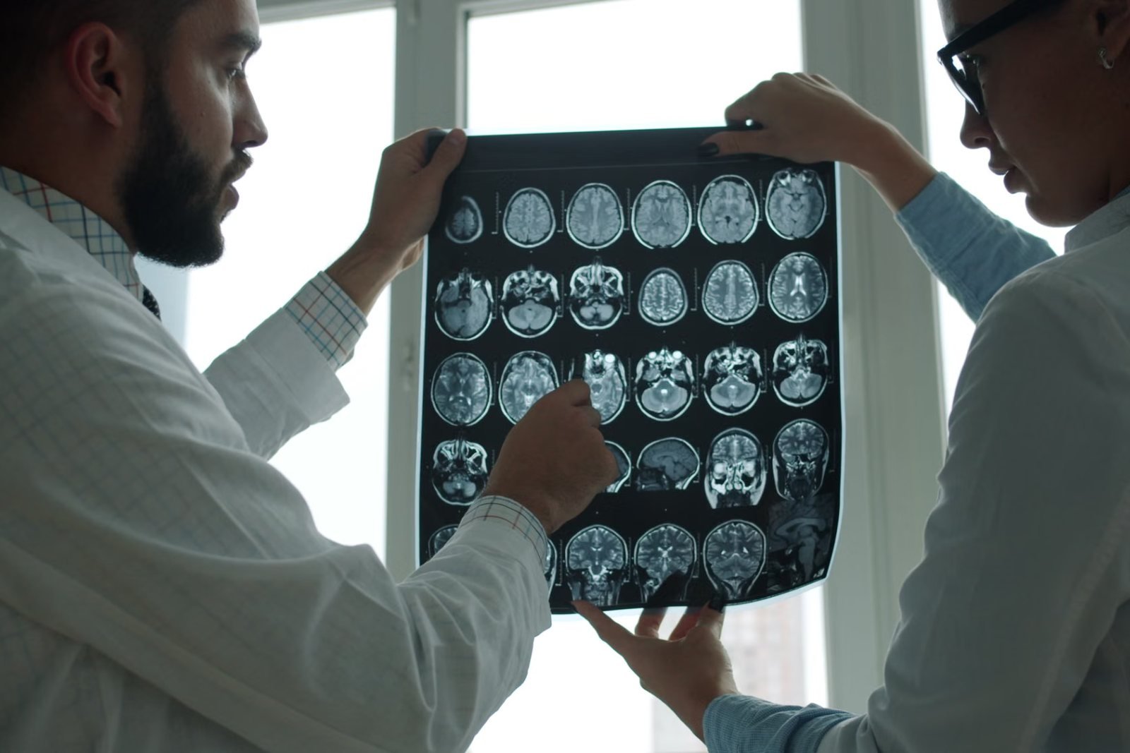 Two clinicians reviewing brain MRI films together