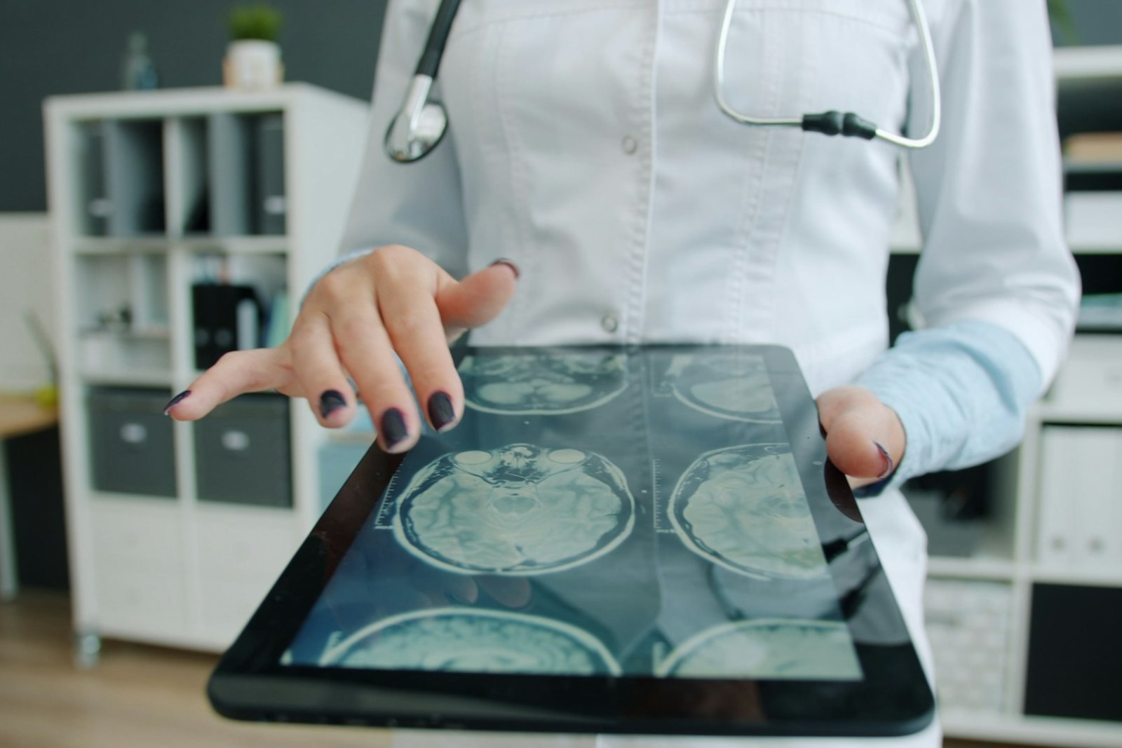 A clinician reviewing MRI images on a tablet