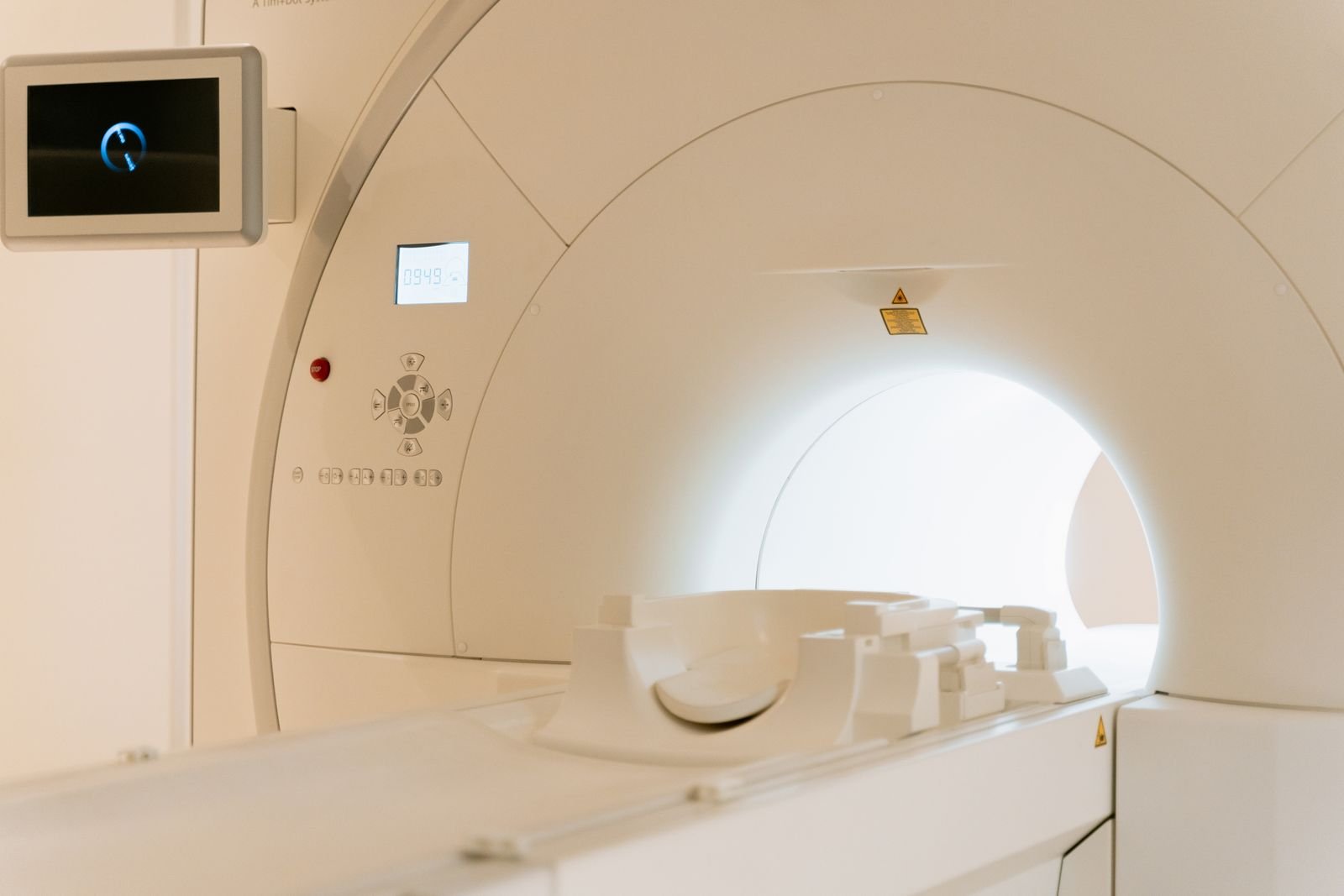 The open bore of an MRI scanner, lit and empty
