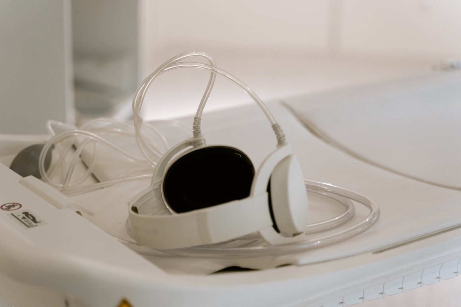 An MRI head coil resting on the scanner table