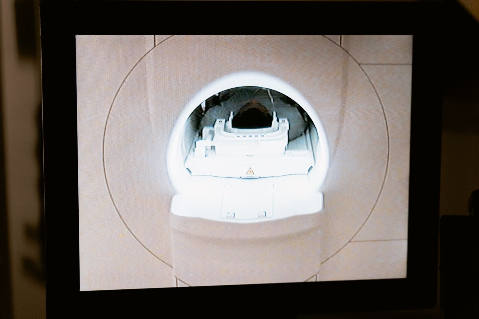 An MRI scanner bore viewed from the control room