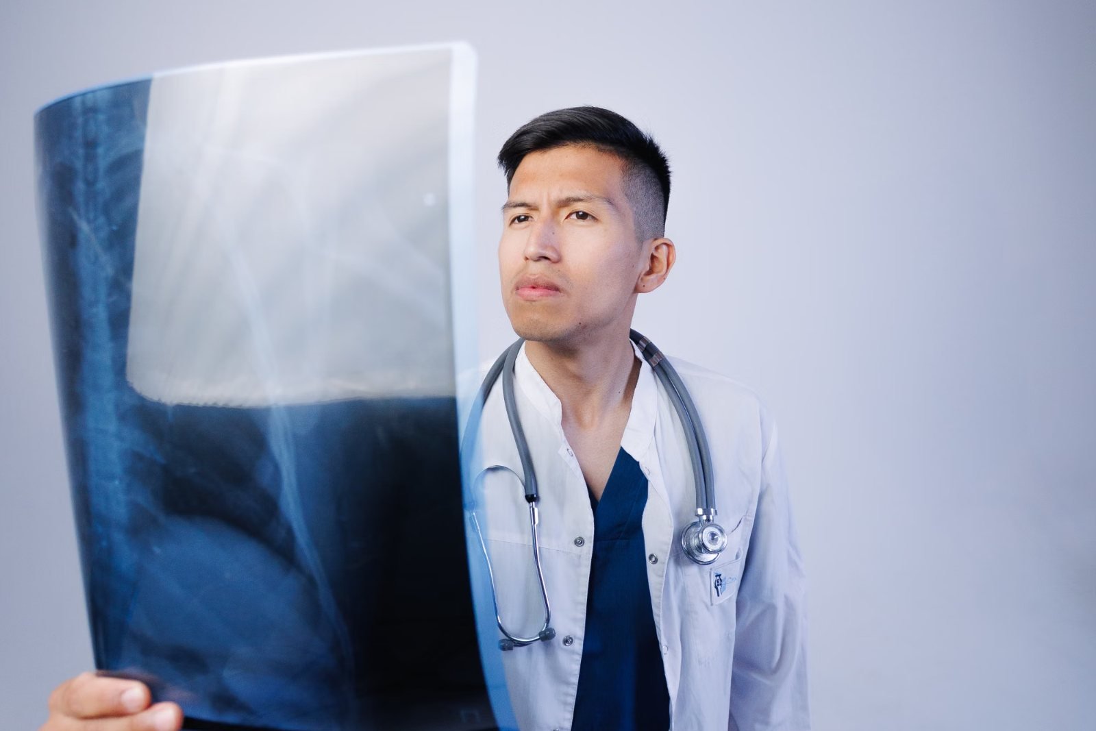 A doctor holding up an X-ray image